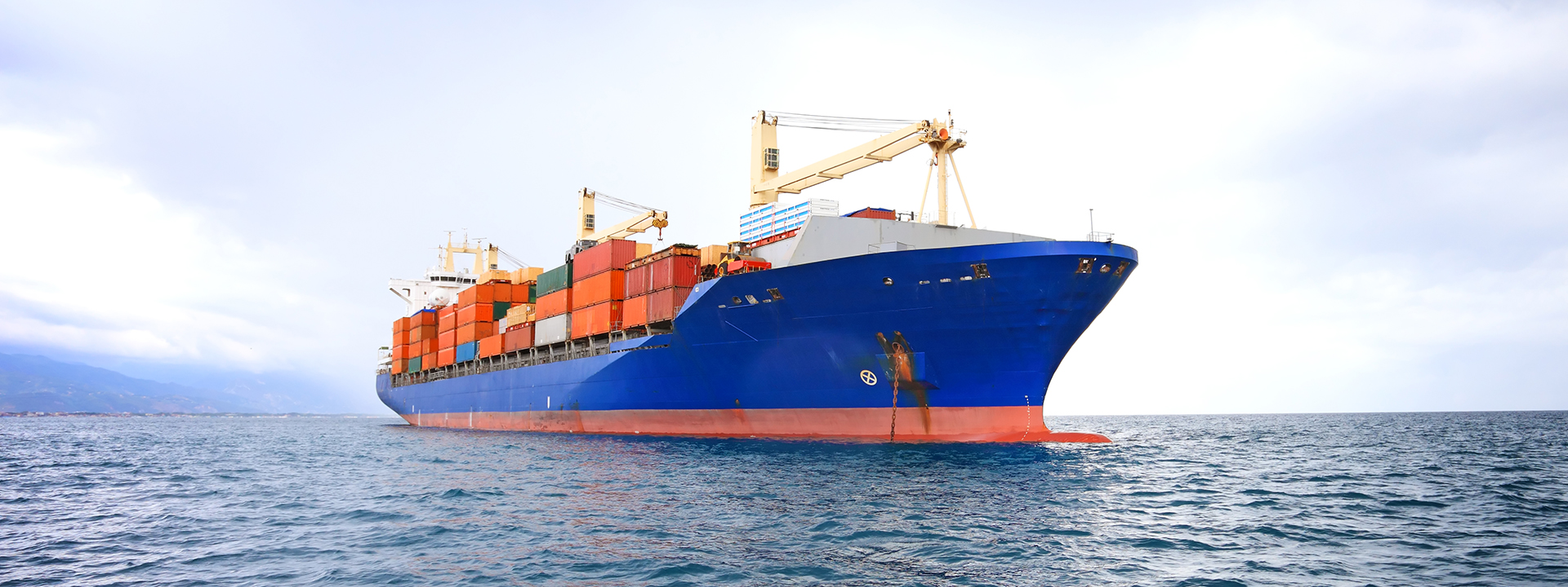 commercial container ship with dramatic sky